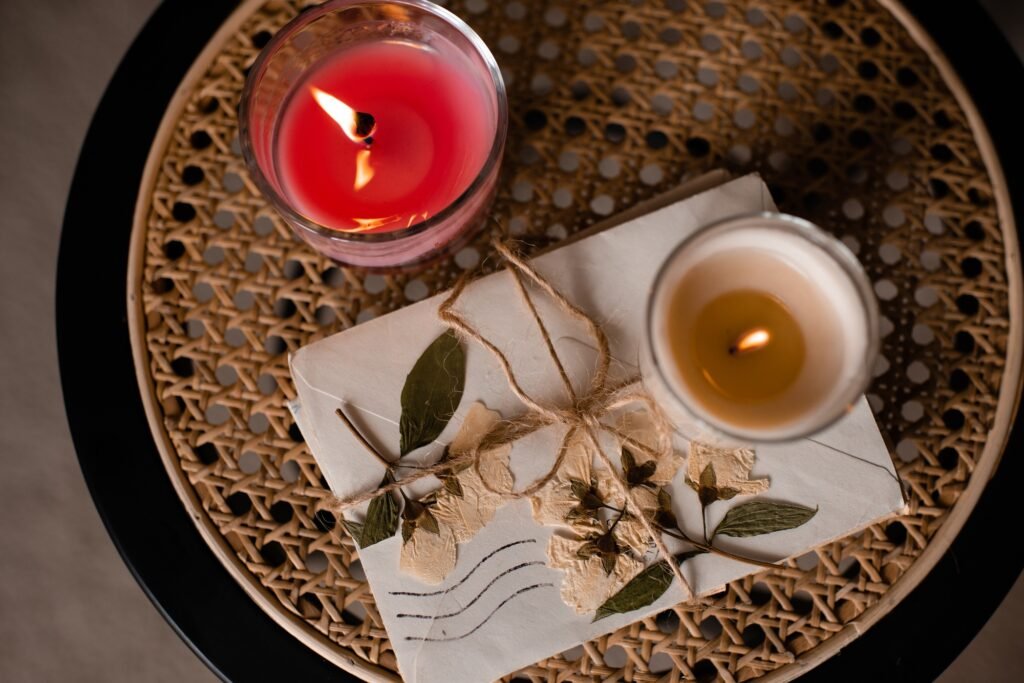 Old vintage love letters with burning candle on rattan table